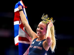 Keely Hodgkinson dons a crown and holds a Union Jack after winning Olympic gold