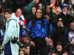 Naomi Girma waves to the crowd at Stamford Bridge after signing for Chelsea