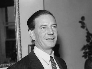 A black and white photo of Kim Philby smiling