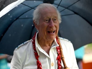 King Charles III holding an umbrella meets local people during his visit to O Le Pupu'Pue National Park, Sa'agafou on the island of Upolu in Samoa