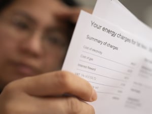 Person looks at energy bill statement