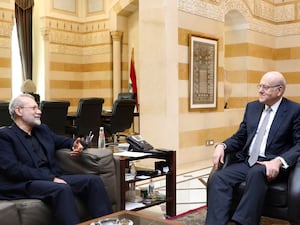 Lebanese caretaker Prime Minister Najib Mikati, right, meets Ali Larijani, an adviser to Iran’s supreme leader Ali Khamenei, in Beirut