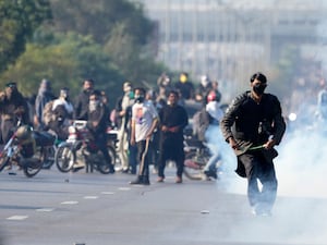 Supporters of jailed Pakistani former premier Imran Khan confront police firing tear gas in Islamabad