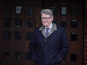 Lord Peter Mandelson in jacket walking outside