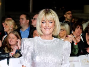 Jane Moore smiling in a white top