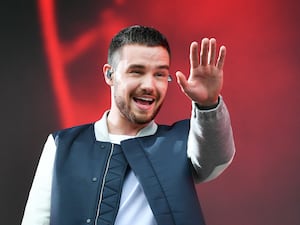 Liam Payne smiling and waving