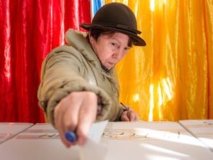 Woman puts vote into ballot box