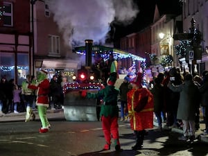 Santa’s Little Helpers arrived on an illuminated steam engine and trailer with music and Disney characters to the delight of the crowds. Image: Andy Compton