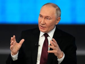 Vladimir Putin gestures as he speaks during his annual news conference