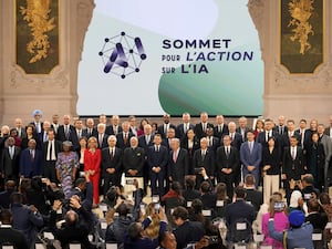 Participants in the AI Action Summit pose for a group photo at the Grand Palais in Paris