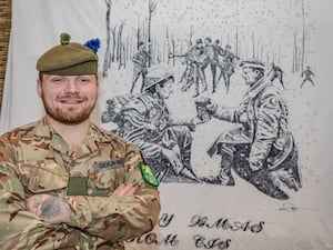 Corporal Lewis Devlin-May with his winning Christmas blanket