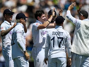 England bowler Matthew Potts, centre, is congratulated by teammates after taking the wicket of New Zealand’s Tom Latham