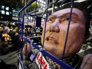 A caricature depicting an imprisoned South Korean President Yoon Suk Yeol is displayed during a rally to demand his impeachment outside the National Assembly