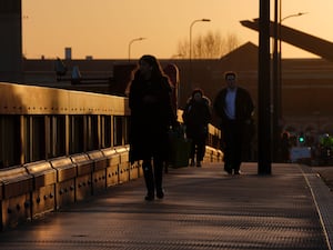 Commuters walk along Vauxhall Bridge, London