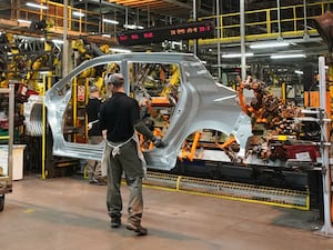 Workers on the production line at a car factory