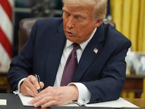 President Donald Trump signs an executive order in the Oval Office