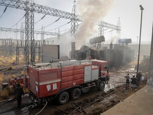 Firefighters work at the scene of an Israeli air strike on a power station in Sanaa, Yemen