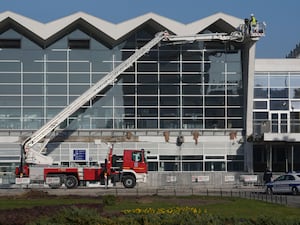 Workers inspect a train station after an outdoor roof collapsed in Novi Sad, Serbia