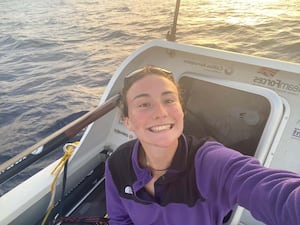 Woman on a rowing boat at sea taking a selfie