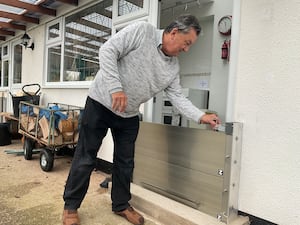 Tony Thorn with one of the flood defences installed to protect the doors to his home at Caersws.