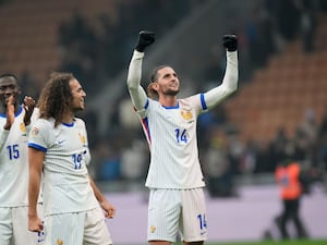 Adrien Rabiot, right, celebrates after the puts both arms in the air as he celebrates France's win