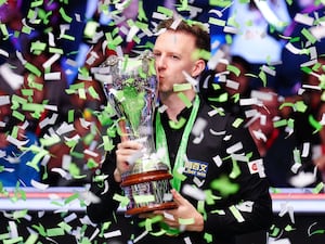 Judd Trump kisses the trophy