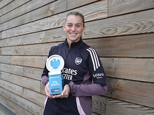 Alessia Russo stands with her Barclays Women's Super League Player of the Month trophy