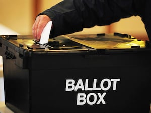 Voter placing a ballot paper in the ballot box