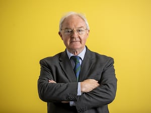 ICRIR chief commissioner Sir Declan Morgan stands with arms folded