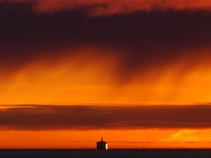 The DFDS King Seaways arrives during the sunrise on the North Sea to the mouth of the Tyne