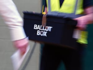 A man holds a ballot box