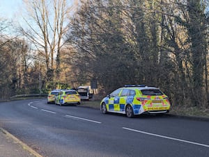 A number of police vehicles are at the scene.