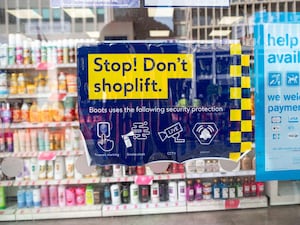 A sign in a window of a Boots shop in central London that reads: 'Stop! Don't shoplift.'