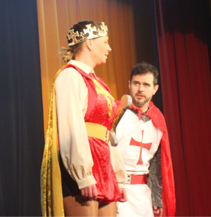 Emily Parkinson Watkins commanding the stage as the noble King Arthur with a Knight of the Round Table