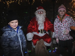 Ethan and Amber Davies, five and seven almost eight, with Santa in his grotto at the switch-on event. Image: Andy Compton