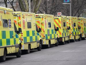 A row of ambulances waiting outside a hospital