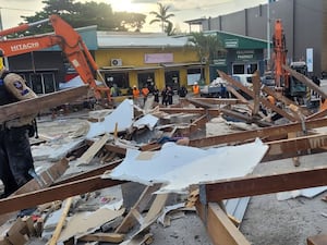 In this photo released by Department of Foreign Affairs and Trade (DFAT), Australian rescue workers inspect a damaged building in Port Vila, Vanuatu