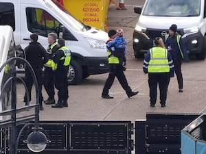 A group of people thought to be migrants, including young children, are brought into Dover, Kent, from a Border Force vessel following a small boat incident in the Channel