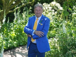 Alan Titchmarsh in a blue suit and yellow tie