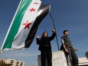 Woman waves Syrian flag