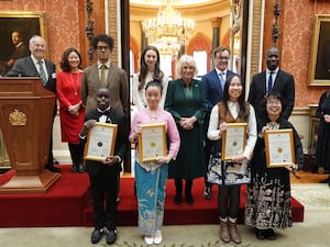 The winners of the competition with the Queen and a number of stars at a palace reception