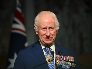 The King with medals on his chest during his tour of Australia