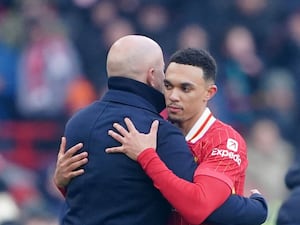 Liverpool’s Trent Alexander-Arnold (right) is embraced by manager Arne Slot