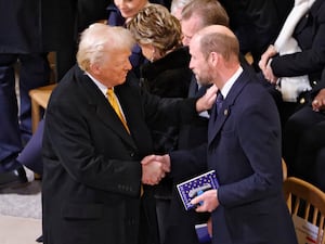 President-elect Donald Trump talks to William