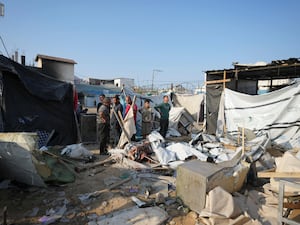 Palestinians gather at the site of an Israeli strike in the courtyard of the Al-Aqsa Hospital in Gaza