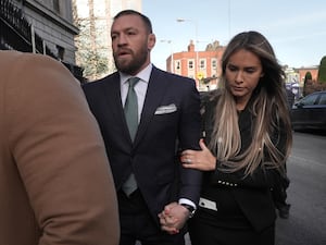 Conor McGregor and partner Dee Devlin outside the High Court in Dublin