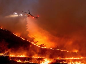 Water is dropped by helicopter on the Kenneth Fire in the West Hills section of Los Angeles