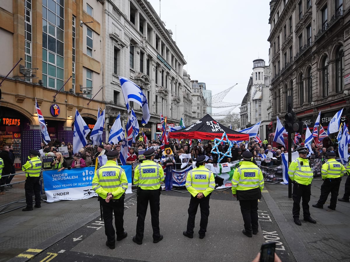 Pro-Palestine group and counter-protesters demonstrate near Christmas shoppers