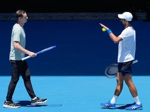 Novak Djokovic (right) talks with his coach Andy Murray during a practice session