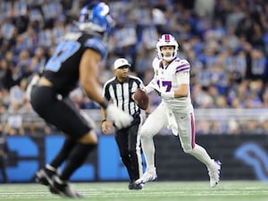 Buffalo Bills quarterback Josh Allen rolls out to pass against the Detroit Lions